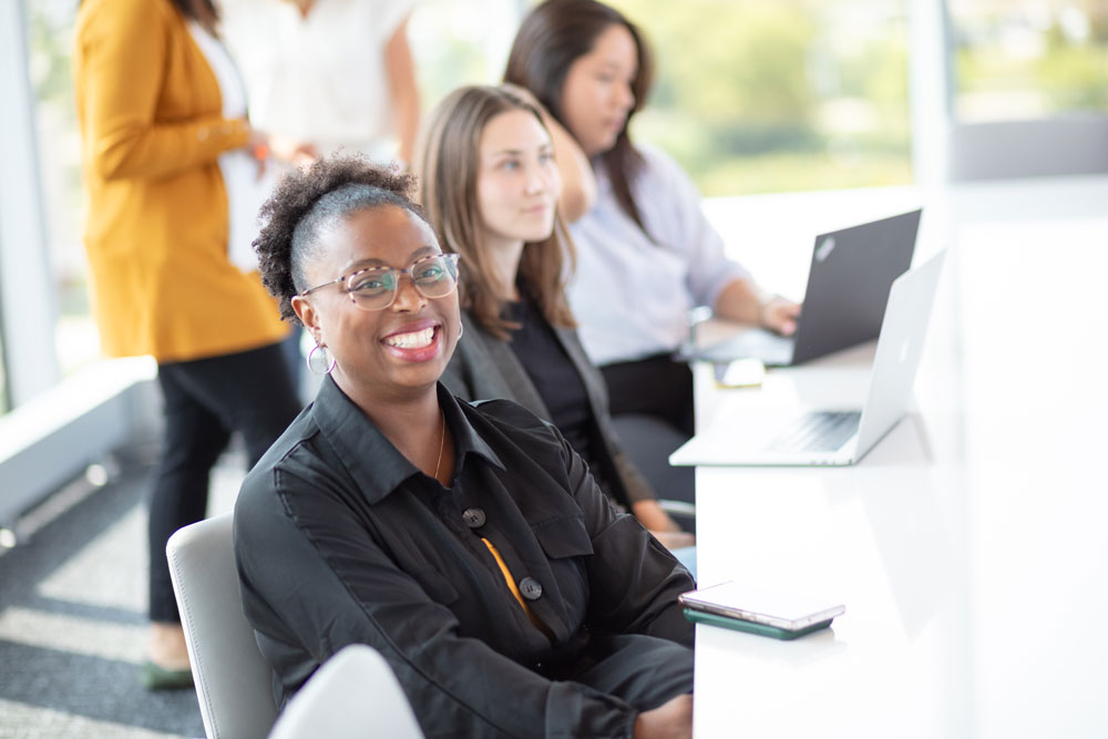 Happy corporate employees having a meeting in a board room